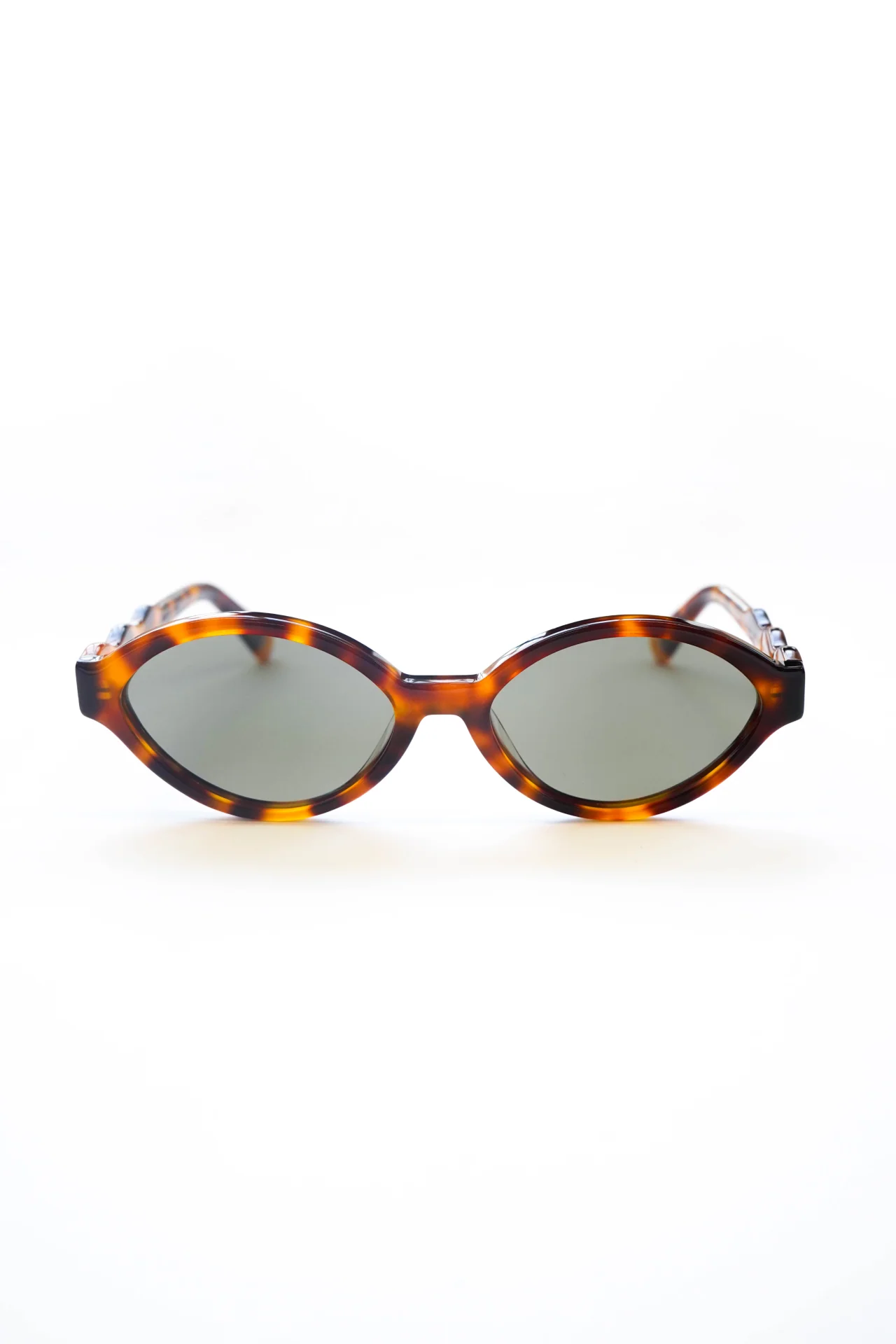 Slim Oval Sunglasses With Wavy Temple In Tort